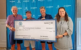 four people hold up a large check