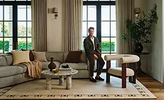 Nate Berkus in a living roon with a rug