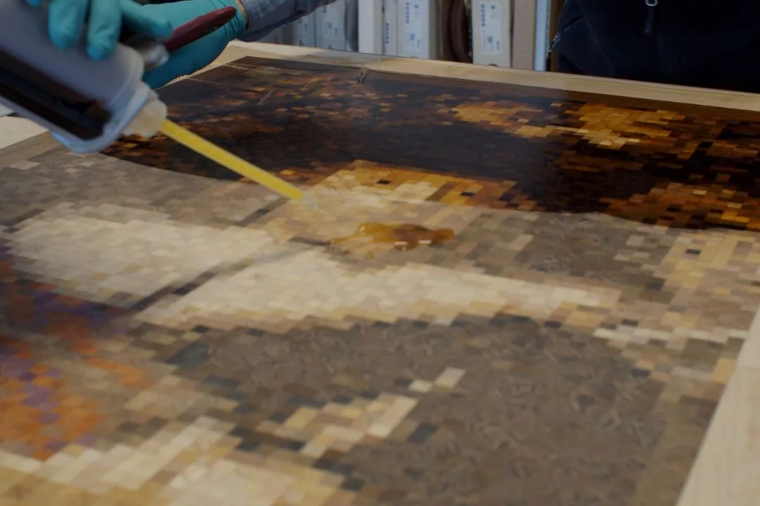 Parquet artist working on the installation