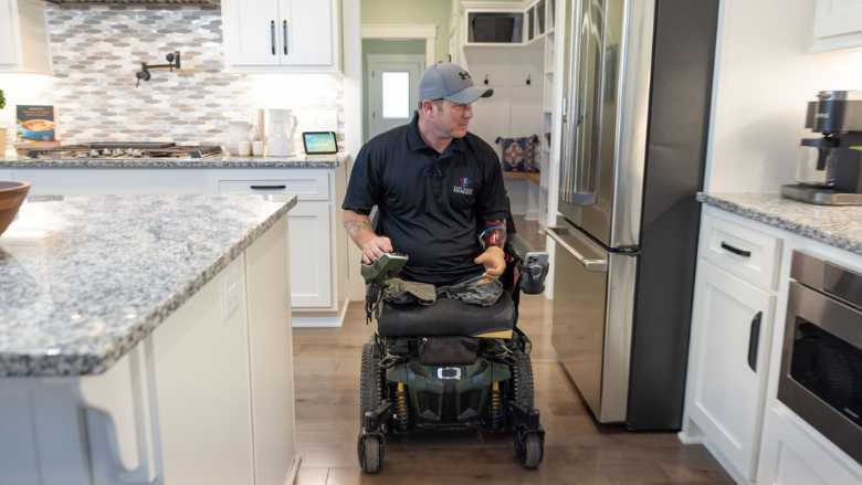 US Army Sergeant Bryan Anderson in adapted kitchen.jpg