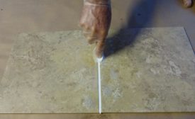 applying sealant to tile