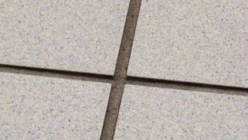 grout that has deteriorated due to routine use of an acid cleaner