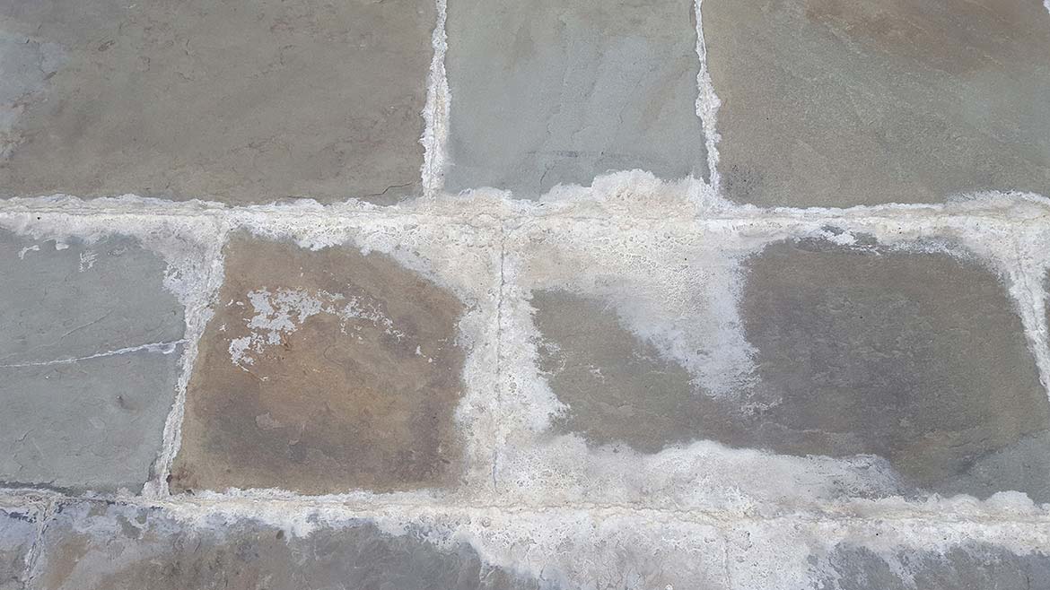 improperly-sloped tile and resulting water damage