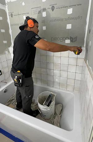 Oscar Barradas installing wall tile