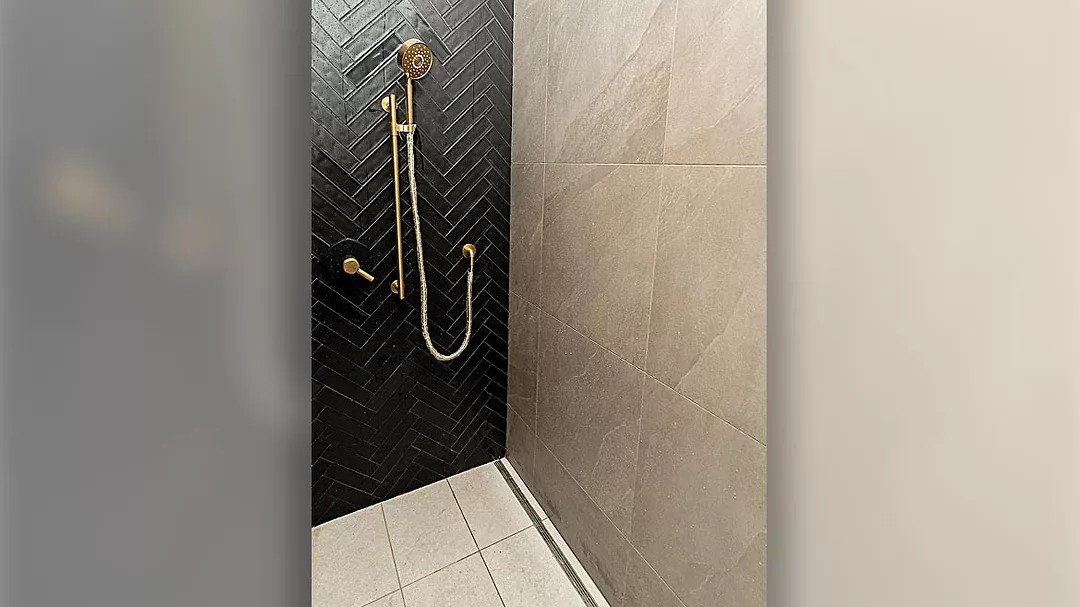 continuous trench-drain system around the entire shower space