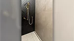 continuous trench-drain system around the entire shower space