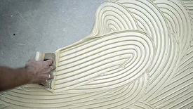 applying adhesive to floor