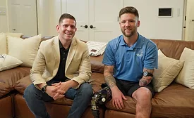 two men sitting on a sofa
