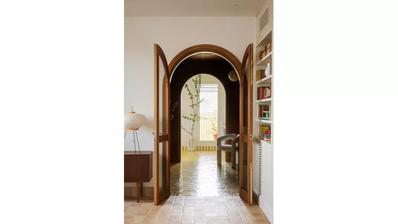 wooden arches separating the entrance hall from the living room
