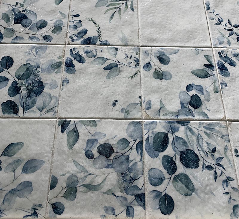 Harmony’s Mayolica collection features neutral tiles paired with floral-patterned tiles
